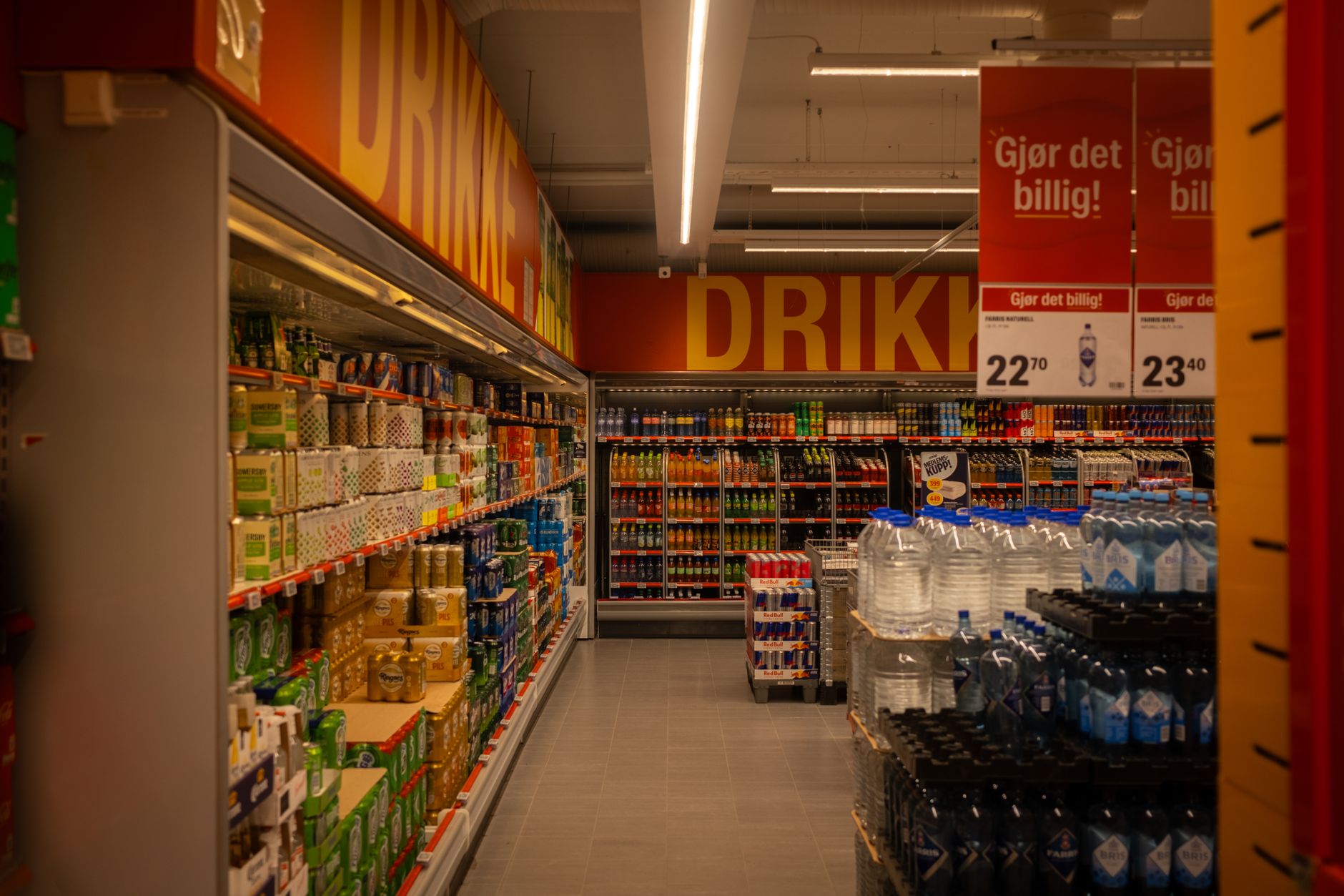 Shopper browsing a grocery store aisle with food products on shelves