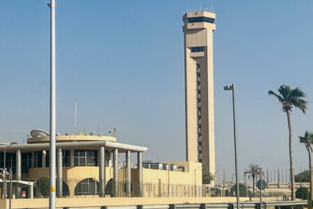 U.S. Pulls Diplomats from Saudi Arabia as Iran Strike Fears Rattle Oil Markets Aerial view of a large oil refinery with smoke stacks in a desert region
