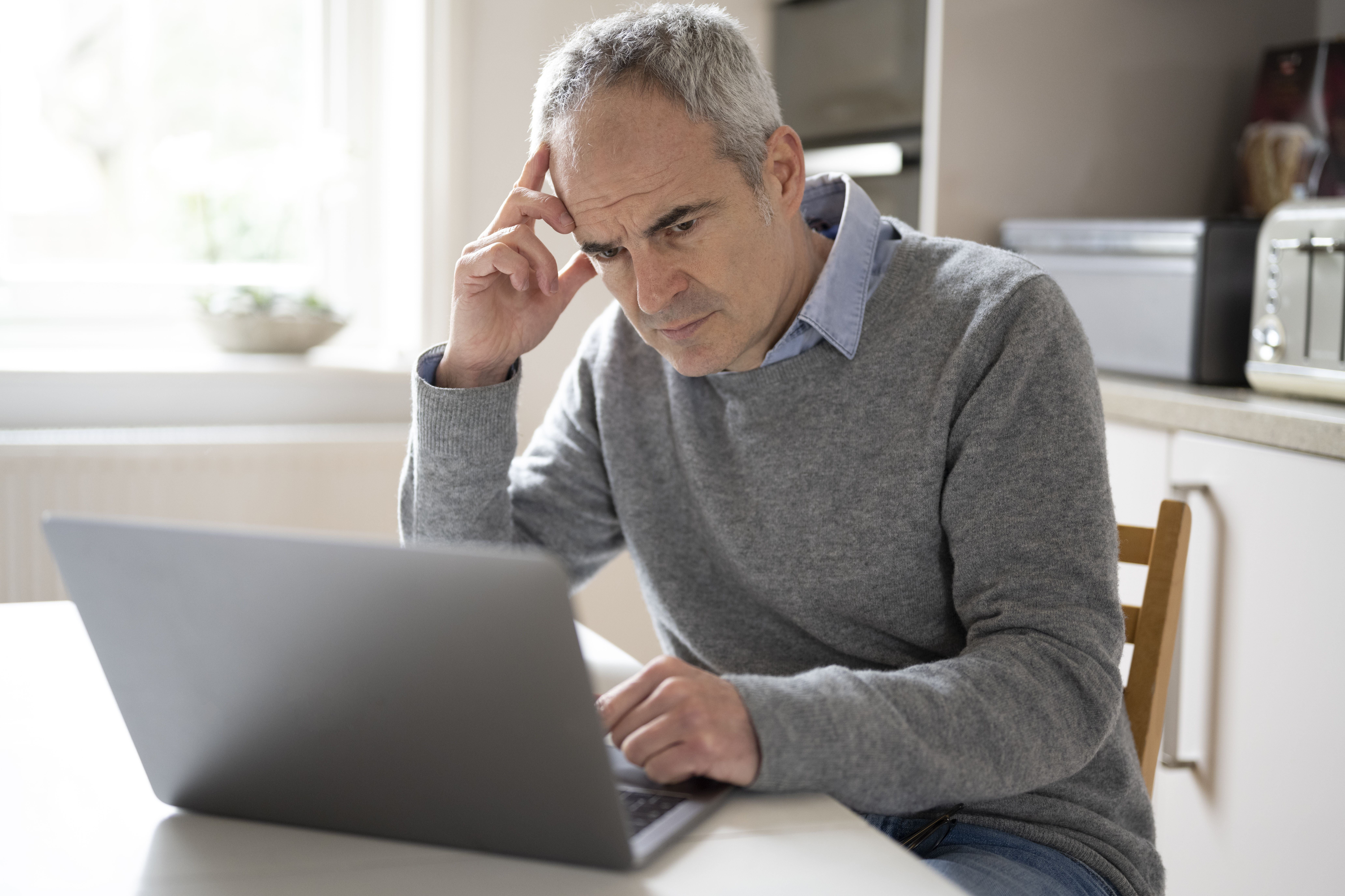 Person reviewing investment portfolio documents and charts at a desk